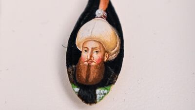 A portrait painted on a pumpkin seed by Turkey's micro artist Hasan Kale.