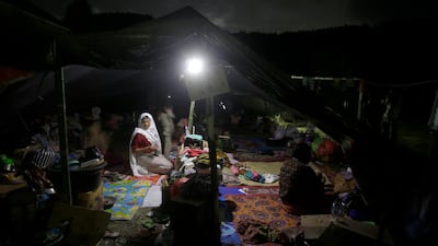 People rest in a tent at a temporary shelter after being displaced by Sunday's earthquake in North Lombok, Indonesia, Thursday, Aug. 9, 2018. AP