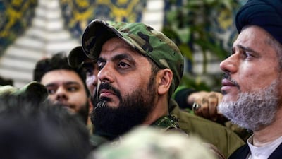 Qais Al Khazali (C) commander of the Asaib Ahl Al Haq pro-Iran faction attends the funeral procession of slain Iraqi paramilitary chief Abu Mahdi Al Muhandis, Iranian military commander Qassem Suleimani and eight others at the Imam Ali Shrine in the shrine city of Najaf in central Iraq on January 4, 2020. AFP