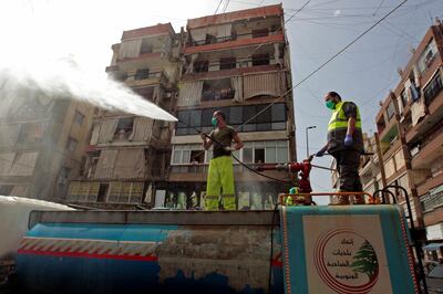 A sanitising crew disinfects a street in southern Beirut during a Hezbollah media tour. Reuters