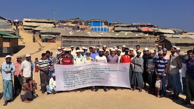 A group of Rohingya refugees hold up a banner that show a list of demands before Bangladesh and Myanmar governments start the process of repatriation, at Kutupalong refugee camp near Cox's Bazar in Bangladesh on January 20, 2018. Rishabh R Jain / AP Photo