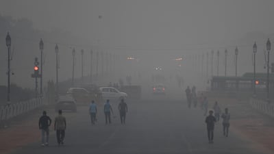 Indian pedestrians walk amid heavy smog conditions in New Delhi. AFP