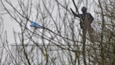 A French special forces member signals as he takes position on a rooftop of the complex. Eric Gaillard / Reuters