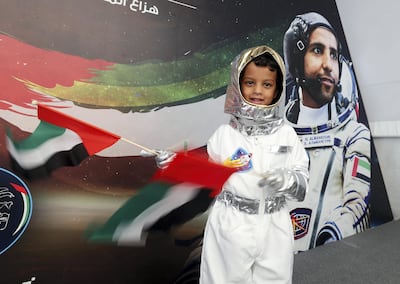 A young boy dressed as an astronaut attends the live call with Emirati Maj Al Mansouri. Chris Whiteoak / The National