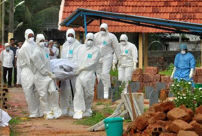 Doctors and relatives carry the body of a man who died after contracting the Nipah virus in Kozhikode, Kerala. Reuters