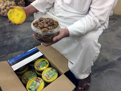 Hajji Hassem holds imported Iranian dates. Sofia Barbarani / The National