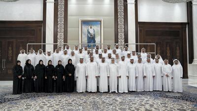 Sheikh Mohammed bin Zayed poses for a photo with General Authority of Islamic Affairs and Endowments employees.