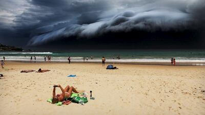 Nature, 1st prize singles, World Press Photo Awards (Rohan Kelly — Storm Front on Bondi Beach) A sunbather is oblivious to the ominous shelf cloud approaching on Bondi beach November 6, 2015. A massive â??cloud tsunamic?? looms over Sydney in a spectacular weather event seen only a few times a year. The enormous shelf cloud rolled in from the sea, turning the sky almost black and bringing violent thunderstorms in its wake. Rohan Kelly / Reuters via WPP