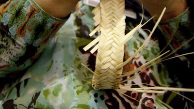 22/07/10 - Abu Dhabi, UAE - A participant weaving a dates basket at the Liwa Dates Festival on Thursday July 22, 2010. (Alyazia Al Yousef / The National)