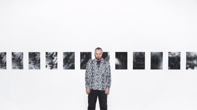 Artist Stelios Kallinikou with his series of photographs capturing rainfall. Reem Mohammed / The National