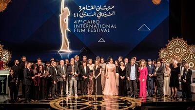 Members of the jury of the 41st edition of the Cairo International Film Festival pose for a group photo with award winners at the conclusion of the festival's closing ceremony at the Cairo Opera House. AFP