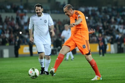 Turkish Prime Minister Recep Tayyip Erdogan, a former semi-professional footballer, takes to the field during an exhibition match at the Basaksehir stadium in 2014. AFP