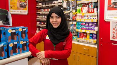 Janet M. Nacional, an employer of ZOOM shop at Etisalat metro station, turned out to be an agent of good luck for Abdullah Eissa, a Syrian National who won the Nissan Grand Raffle. Victor Besa for The National.