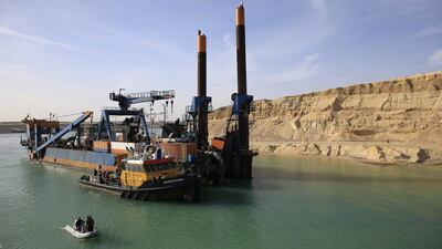 A dredger works on a new section of the Suez Canal during a media tour in Ismailia, Egypt. The Suez Canal Authority is in a race to quickly expand the vital waterway for two-way traffic by August 2015. Hassan Ammar / AP Photo