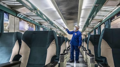 An Egyptian worker sprays disinfectant inside a train at Cairo's Ramses railway station. AFP