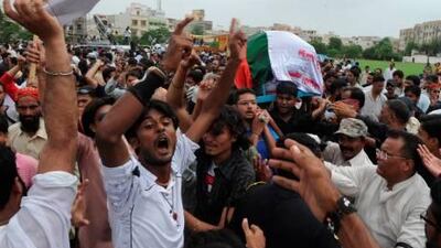 Pakistan's Muttahida Qaumi Movement (MQM) supporters chant slogans during the funeral procession of murdered MQM leader Raza Haider in Karachi on August 3.