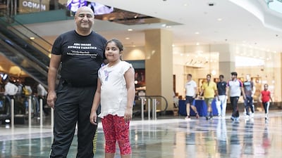 Shahzad Ahmed and his daughter Aisha, 8, join the other members of the Active Weekend group to participate in a 20-minute to 45-minute walk or run at Abu Dhabi Mall. Mona Al Marzooqi/ The National