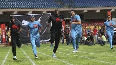 Yuvraj Singh, second right, jokingly tries to push Usain Bolt during a 100-metre friendly sprint in Bangalore on Tuesday. Aijaz Rahi / AP