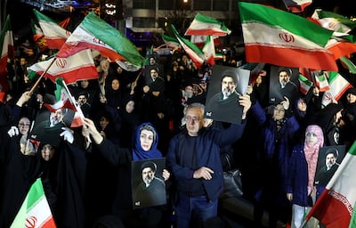 Iranian people chant, wave flags and hold posters of the new Iranian supreme leader Mojtaba Khamenei during a rally in support for the military, in Tehran. EPA