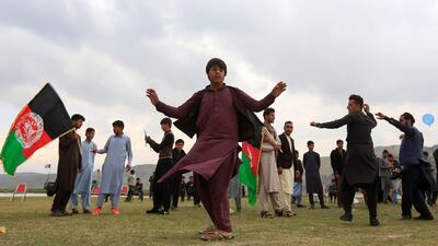 Afghan men celebrate in anticipation of the U.S-Taliban agreement to allow a U.S. troop reduction and a permanent ceasefire, in Jalalabad, Afghanistan. REUTERS
