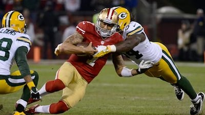 San Francisco 49ers quarterback Colin Kaepernick is tackled by Green Bay Packers linebacker Dezman Moses.