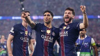 PSG players Achraf Hakimi and Khvicha Kvaratskhelia celebrate after defeating Arsenal in the Uefa Champions League final. Getty Images