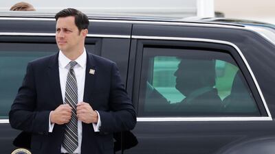 A body guard stands in front of US president Donald Trump's car after he disembarked form Air Force One on July 13, 2017 at Paris' Orly airport, beginning a 24 hour trip that coincides with France's national day and the 100th anniversary of US involvement in World War I. Thomas Samson / AFP