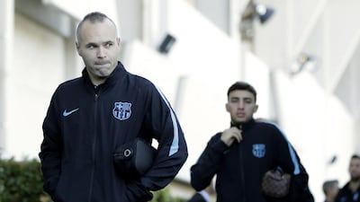 Andres Iniesta, left, arrives for training. Kiyoshi Ota / EPA