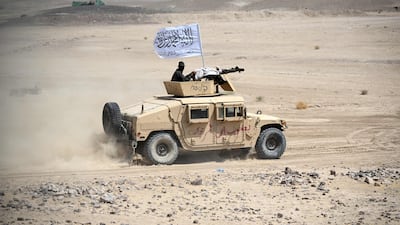 Taliban security personnel travel in an armoured vehicle during celebrations marking Afghanistan's Independence Day in the Arghistan district of Kandahar province. AFP