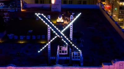 Workers install lighting on an 'X' sign atop the company headquarters, formerly known as Twitter, in San Francisco, in July. AP Photo