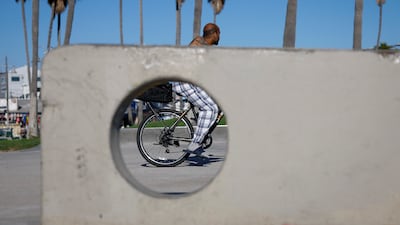 A person cycles along Venice Beach in Los Angeles, California. EPA