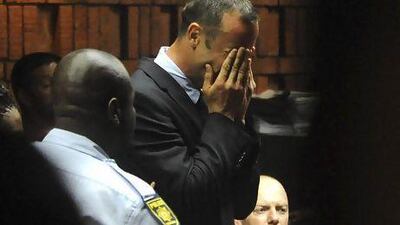 Oscar Pistorius weeps as he appears in a Pretoria court after spending the night in police custody. His bail hearing was postponed until Tuesday.