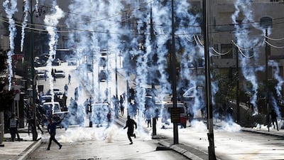 Israeli borderpolice shoot tear gas at Palestinians in the West Bank city of Bethlehem on December 18, 2015. Abed Al Hashlamoun/EPA