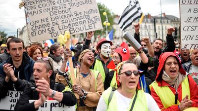 People take part in a demonstration called by the "Yellow vest" (Gilets jaunes) movement on May 11, 2019 in Nantes, western France. / AFP / Sebastien SALOM-GOMIS