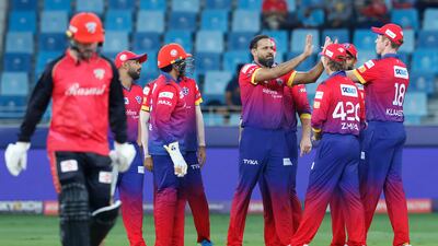 Dubai Capitals' Yusuf Pathan celebrates the wicket of Colin Munro of Desert Vipers.