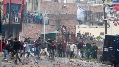 In this February 15, 2019 photo, protesters throw stones following an attack on a paramilitary convoy in Kashmir, in Jammu, India. AP