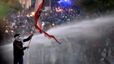 Lebanese riot police spray water cannons to disperse anti-government protesters during a protest outside of the Lebanese Parliament in downtown Beirut. EPA