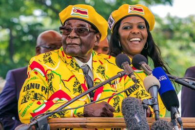 Zimbabwe's President Robert Mugabe addressing party members and supporters gathered at his party headquarters to show support to Grace Mugabe, right, becoming the party's next Vice President after the dismissal of Emerson Mnangagwa. AFP PHOTO / Jekesai NJIKIZANA