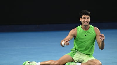 Carlos Alcaraz collapses to the court after defeating Alexander Zverev in a marathon five-set semi-final to reach the Australian Open title match. EPA
