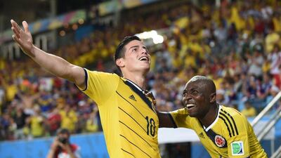James Rodriguez celebrates his goal against Japan on Tuesday with Colombia teammate Pablo Armero at the 2014 World Cup in Cuiaba, Brazil. Toshifumi Kitamura / AFP