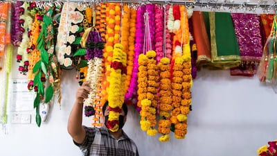 A stoke keeper arranges the flowers at a Hindu flower shop in Bur Dubai. Reem Mohammed / The National