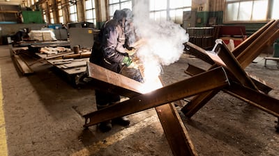 A worker welds metal inside the Interpipe Steel plant in Dnipro, Ukraine. Exports of steel gas pipes to Texas oil companies and railway wheels to European high-speed train operators has been put on hold as hundreds of the company’s 10,000 employees in the country have joined the fight against Russia. Working with a skeleton crew, Interpipe facilities are running canteens and making metal barriers to block Russian tanks and convoys. At night, its bomb shelters house dozens of local families. AP
