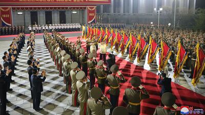 Mr Kim and his wife review a guard of honour. AP