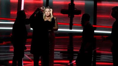 Host Kelly Clarkson has her make-up retouched before the start of the Billboard Music Awards. AP