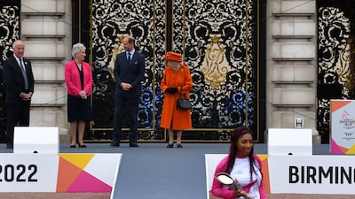 Kadeena Cox, the first baton-bearer commences the baton's journey back in October 2021, as Queen Elizabeth watches on. AFP