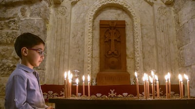 A Syrian Christian boy attends Easter Sunday mass at the Forty Martyrs Armenian church in the northern city of Aleppo in April 2022. AFP