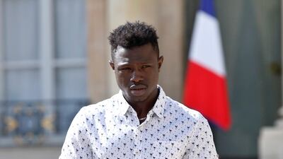 Mamoudou Gassama from Mali leaves the presidential Elysee Palace after his meeting with French President Emmanuel Macron in Paris, France, 28 May 2018. The 22-year-old migrant is being honored by Macron for scaling an apartment building over the weekend to save a 4-year-old child dangling from a fifth-floor balcony. Thibault Camus / EPA