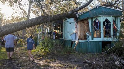 Nash Harris and his mother Alicia hoping to salvage belongings after Hurricane Helene brought a tree down on their home in Steinhatchee, Florida. Reuters