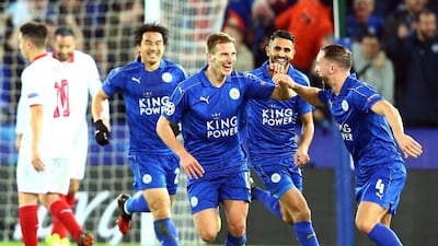 Leicester City players celebrate with Marc Albrighton after he scored the second goal in the 2-0 victory over Sevilla on Tuesday night. Tim Keeton / EPA