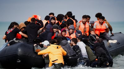 Migrants attempting to cross the English Channel to reach Britain on September 4 crowd on to an inflatable dinghy. Reuters